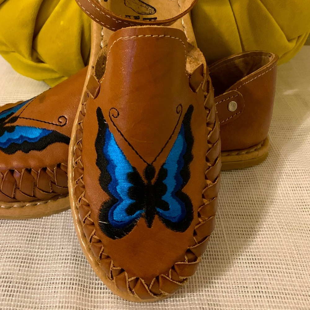 Aqua blue and black butterfly embroidered. Side gold buckle. Adjustable.
